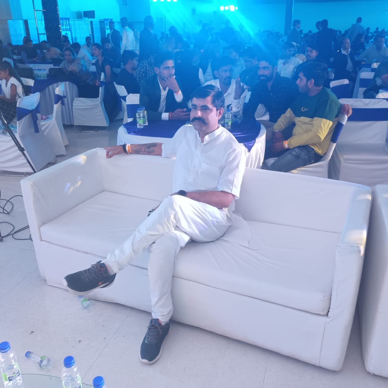 Sanjay Mehta seated at a large conference venue